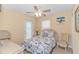 Bedroom featuring a ceiling fan, access to balcony and ocean themed bed spread at 6001- 310 S Kings Hwy., Myrtle Beach, SC 29575