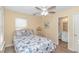 Cozy bedroom features nautical bedding, ceiling fan, and ensuite bathroom access at 6001- 310 S Kings Hwy., Myrtle Beach, SC 29575