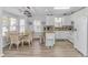 Bright kitchen and dining area with white cabinets, stainless appliances, and ample seating at a table at 6001- 310 S Kings Hwy., Myrtle Beach, SC 29575