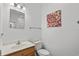 Bright half bathroom featuring a wood vanity, mirror, updated fixtures and decor at 6001- L08 S Kings Hwy., Myrtle Beach, SC 29575