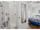 Modern bathroom showing a shower with blue and white curtain and ensuite access to a bedroom at 6001- L08 S Kings Hwy., Myrtle Beach, SC 29575