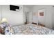 Comfortable bedroom featuring a TV, colorful bedspread, and access to an ensuite bathroom at 6001- L08 S Kings Hwy., Myrtle Beach, SC 29575