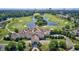 Aerial view of a stunning golf course community featuring lush greenery, water features, and a grand clubhouse at 6096 Campanella St., Myrtle Beach, SC 29577