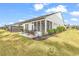 Backyard features a lawn, patio, flower bed, and screened-in porch of the home at 6096 Campanella St., Myrtle Beach, SC 29577