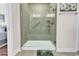 Tiled shower features a grab bar, built-in seat and shelving, and a glass door at 6096 Campanella St., Myrtle Beach, SC 29577