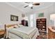 Cozy bedroom with a ceiling fan, a comfortable bed with patterned quilts, and tasteful decor at 6096 Campanella St., Myrtle Beach, SC 29577
