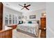 Cozy bedroom boasts a decorative ceiling fan and a large window for natural light at 6096 Campanella St., Myrtle Beach, SC 29577
