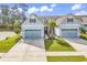 Charming exterior of a two-story home with a well-manicured lawn, a blue garage door and lovely landscaping at 6096 Campanella St., Myrtle Beach, SC 29577