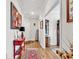 Bright hallway features wood floors, a decorative console table, and an open doorway to adjoining rooms at 6096 Campanella St., Myrtle Beach, SC 29577