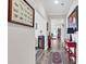 Bright hallway features wood floors, a decorative console table, and an open doorway to adjoining rooms at 6096 Campanella St., Myrtle Beach, SC 29577