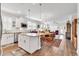 Open-concept kitchen and dining area with stainless steel appliances and wood floors at 6096 Campanella St., Myrtle Beach, SC 29577