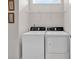 Functional laundry room featuring a washer, dryer, and overhead shelving, providing efficient space utilization at 6096 Campanella St., Myrtle Beach, SC 29577