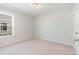 This carpeted bedroom features a window and interior door at 633 Woodside Dr., Conway, SC 29526