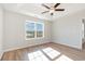 This bedroom has a ceiling fan, wood floor, and a large window with natural light at 633 Woodside Dr., Conway, SC 29526