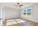 This bedroom has a ceiling fan, wood floor, large window and tray ceiling at 633 Woodside Dr., Conway, SC 29526
