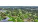 Scenic aerial view featuring a beautiful golf course with mature trees, ponds, and residential areas at 653 Whispering Pines Ct., Murrells Inlet, SC 29576
