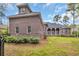 Beautiful brick home with manicured lawn and covered porch supported by tall columns, perfect for relaxing outside at 653 Whispering Pines Ct., Murrells Inlet, SC 29576