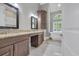 Luxurious bathroom featuring dual vanities, granite counters, soaking tub, and marble tile flooring at 653 Whispering Pines Ct., Murrells Inlet, SC 29576