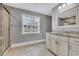 Well-lit bathroom featuring a window, granite countertops, and a glass enclosed shower for a spa-like experience at 653 Whispering Pines Ct., Murrells Inlet, SC 29576