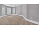 Large bedroom has neutral carpet, base trim, ceiling fan and multiple windows at 653 Whispering Pines Ct., Murrells Inlet, SC 29576