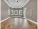 Spacious bedroom features hardwood floors, a ceiling fan, and abundant natural light at 653 Whispering Pines Ct., Murrells Inlet, SC 29576