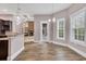 Bright dining area adjacent to kitchen, featuring natural light, and open to Gathering room with fireplace at 653 Whispering Pines Ct., Murrells Inlet, SC 29576