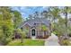 Beautiful brick two-story home featuring professional landscaping and a paved driveway at 653 Whispering Pines Ct., Murrells Inlet, SC 29576