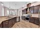 Well-equipped kitchen with granite counters, dark wood cabinetry, and stainless steel appliances at 653 Whispering Pines Ct., Murrells Inlet, SC 29576