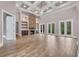 Grand living room features coffered ceilings, stone fireplace and tile floors at 653 Whispering Pines Ct., Murrells Inlet, SC 29576