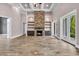 Spacious living room features coffered ceilings, stone fireplace and tile floors at 653 Whispering Pines Ct., Murrells Inlet, SC 29576