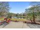 Inviting backyard with a patio seating area, palm trees and a scenic view of the community pond at 742 Camden Circle, Pawleys Island, SC 29585