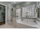 Bright bathroom with a garden tub and a glass enclosed shower at 742 Camden Circle, Pawleys Island, SC 29585
