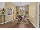 Bright dining room featuring hardwood floors, a chandelier, and a large window with natural light at 742 Camden Circle, Pawleys Island, SC 29585