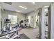 Well-equipped fitness center featuring modern exercise machines, natural light and comfortable flooring at 742 Camden Circle, Pawleys Island, SC 29585