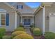 Inviting home entrance featuring double doors, manicured shrubbery, and decorative wreaths at 742 Camden Circle, Pawleys Island, SC 29585