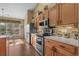 Kitchen with stainless steel appliances and wooden cabinets at 742 Camden Circle, Pawleys Island, SC 29585