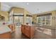 Bright eat-in kitchen featuring an island, lots of sunlight, and views of the outdoor patio at 742 Camden Circle, Pawleys Island, SC 29585