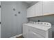 Functional laundry room featuring a white washer and dryer set and coordinating cabinetry at 742 Camden Circle, Pawleys Island, SC 29585