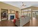 Bright living room featuring a fireplace, large windows, hardwood flooring, and a comfortable seating area at 742 Camden Circle, Pawleys Island, SC 29585