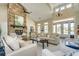 Inviting living room showcasing a grand stone fireplace, soaring ceilings, and abundant natural light at 742 Camden Circle, Pawleys Island, SC 29585