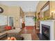 Inviting living room with a fireplace, hardwood floors, and an open doorway leading to other rooms at 742 Camden Circle, Pawleys Island, SC 29585