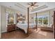 Elegant main bedroom with a four-poster bed and large windows overlooking the lake at 742 Camden Circle, Pawleys Island, SC 29585