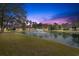 Scenic view of a tranquil pond with a fountain, creating a serene backdrop for a quiet neighborhood at 742 Camden Circle, Pawleys Island, SC 29585