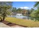 Scenic pond view with a fountain, surrounded by well-maintained lawns and mature trees at 742 Camden Circle, Pawleys Island, SC 29585