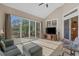 Bright sunroom featuring tile flooring, modern furniture, and expansive views of the water and lush greenery at 742 Camden Circle, Pawleys Island, SC 29585
