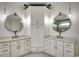 Elegant bathroom with dual vanities, stylish lighting, and central linen storage, offering a symmetrical and sophisticated design at 804 Waterton Ave., Myrtle Beach, SC 29579