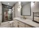 Modern bathroom with a sleek vanity, marble countertop, stylish lighting, and glass-enclosed shower with herringbone tiling at 804 Waterton Ave., Myrtle Beach, SC 29579