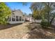 Backyard view featuring a patio area, sunroom addition, and decorative landscaping at 808 Arbor Ln., North Myrtle Beach, SC 29582