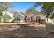 Backyard view featuring a spacious deck, sunroom addition, and well-maintained landscaping at 808 Arbor Ln., North Myrtle Beach, SC 29582