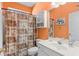 Bathroom featuring a white sink, ornate mirror, decorated shower curtain, and orange walls at 808 Arbor Ln., North Myrtle Beach, SC 29582